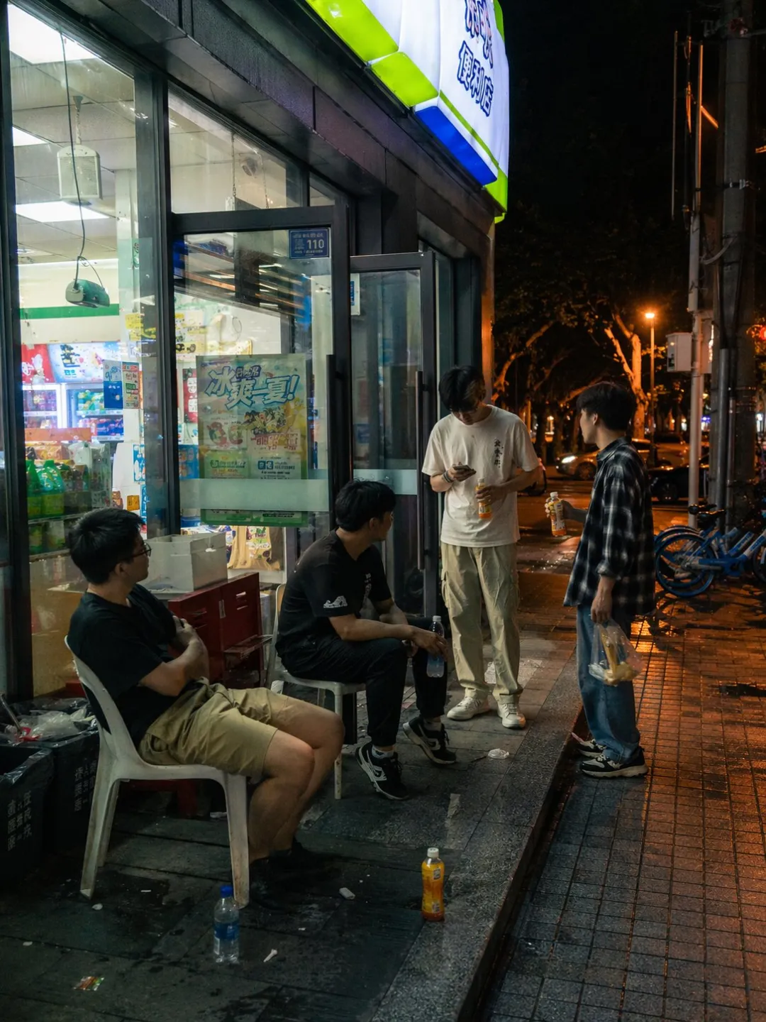 Rainy Tokyo street at night with neon reflections and a lone figure with umbrella